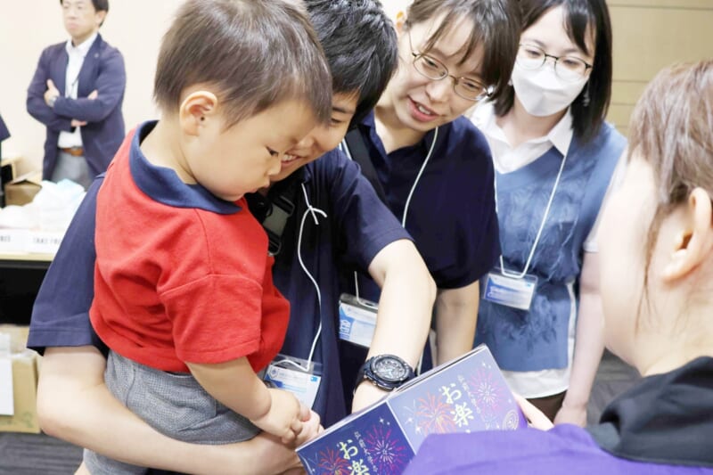 福引をする卒業生とその家族の写真
